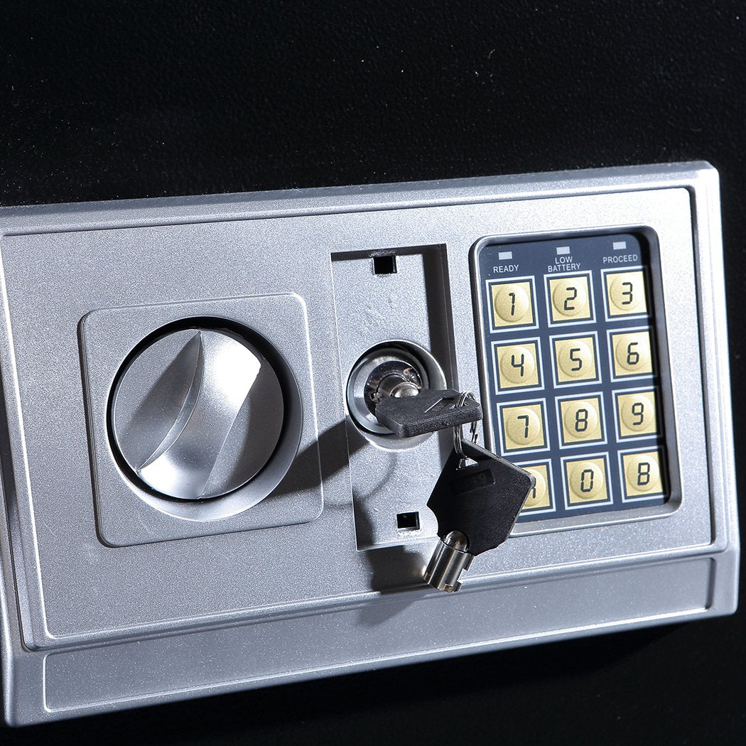 Metallic safe box with keypad lock on a black background