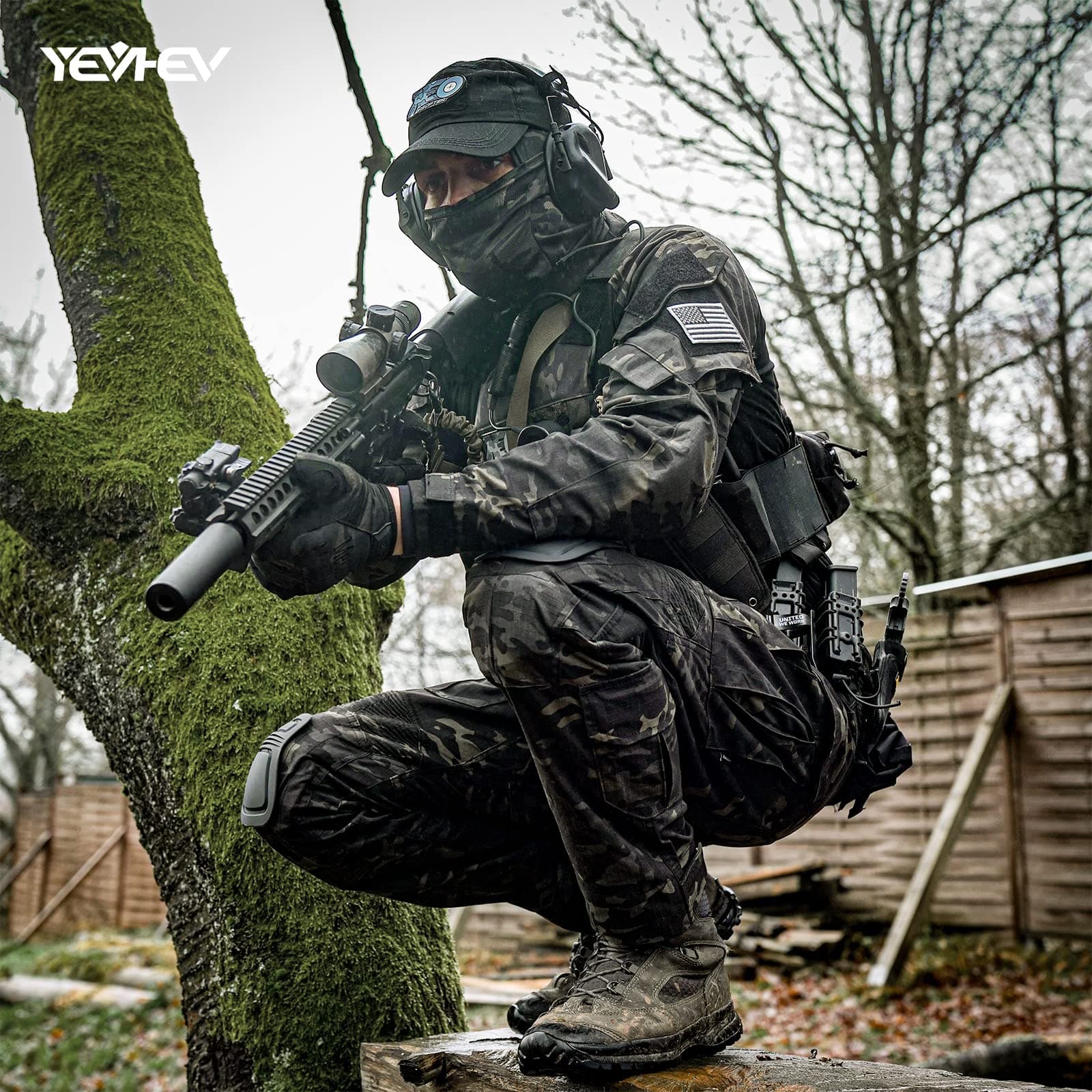 Person in tactical gear crouching behind a tree in an outdoor setting