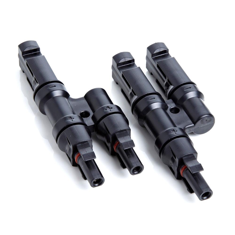 Four black plastic connectors on a white background