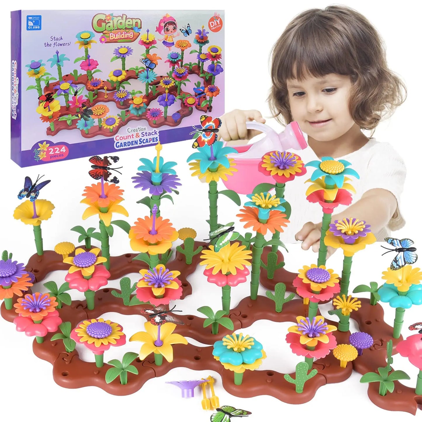 Child playing with a colorful toy garden set, including flowers and a watering can, with the packaging in the background.