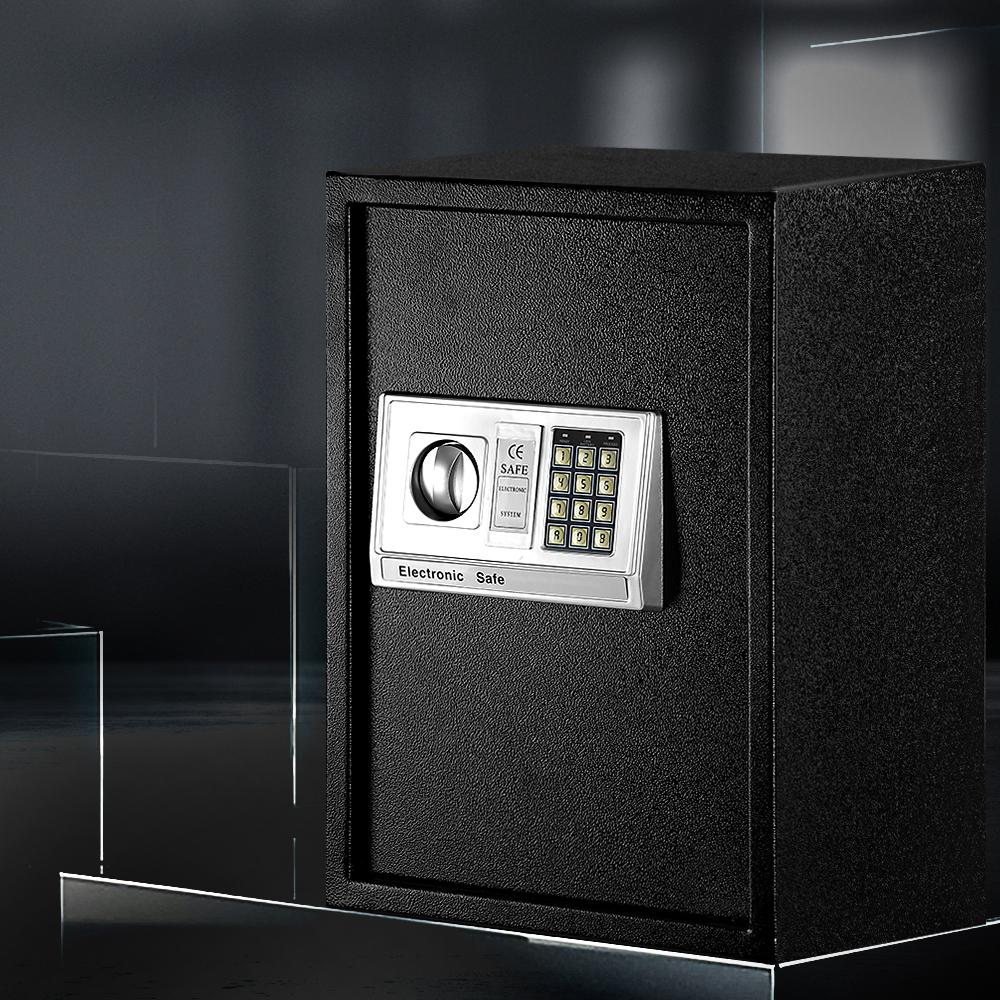 Black electronic safe box with digital keypad on a dark background