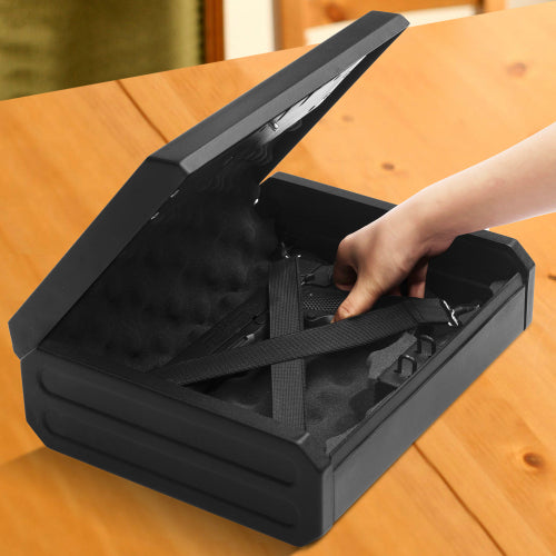 Black carrying case with a hand reaching inside on a wooden surface