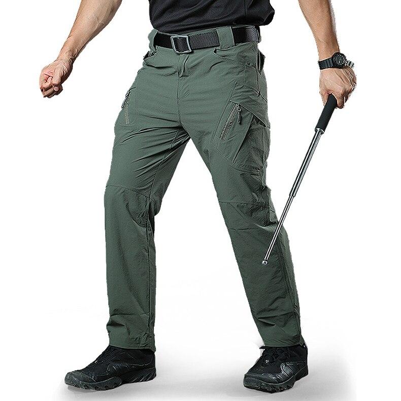 Person wearing green tactical pants with a white background